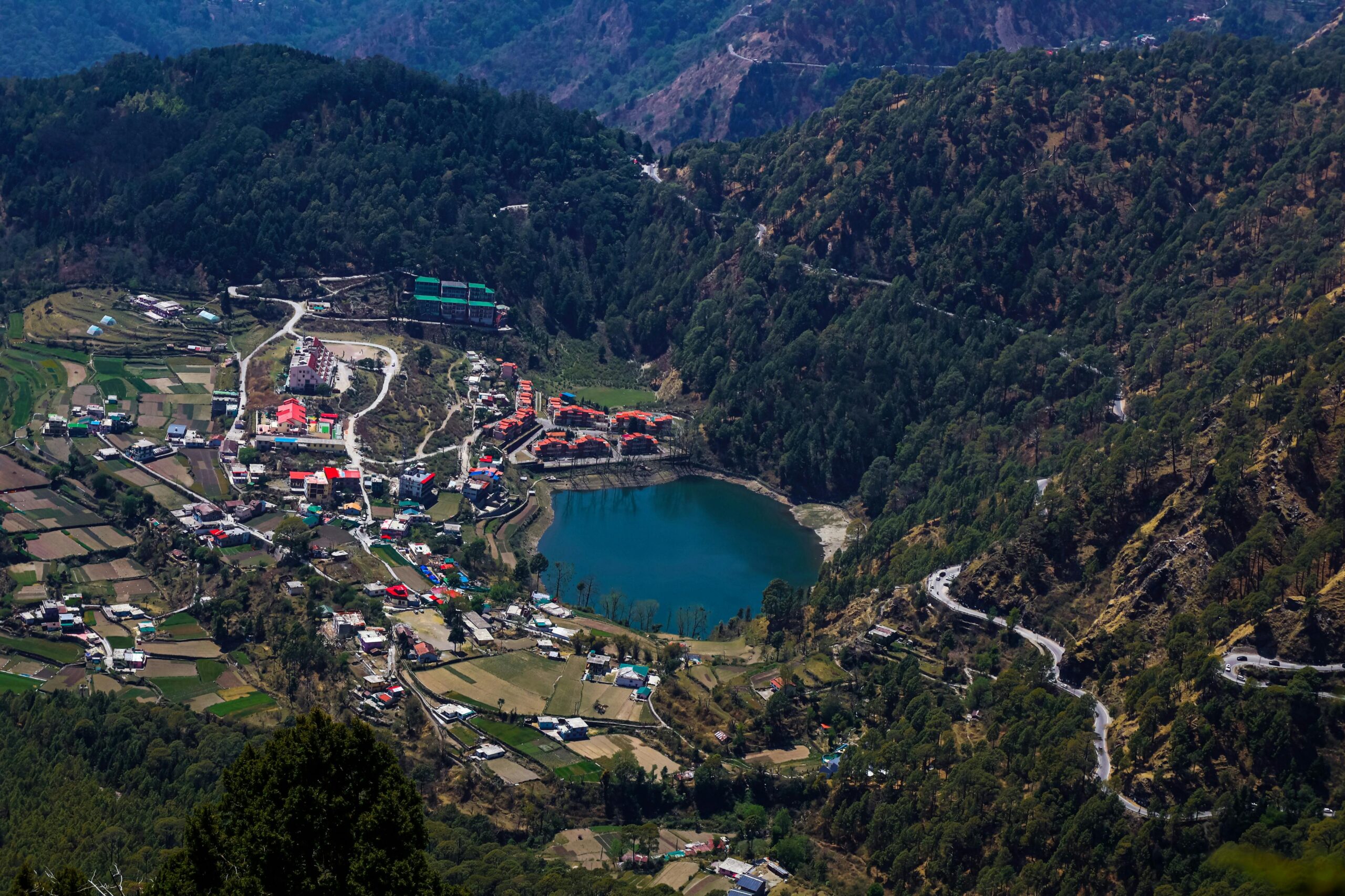 Scenic aerial shot of Bhimtal Lake surrounded by hills and town in Nainital, India.